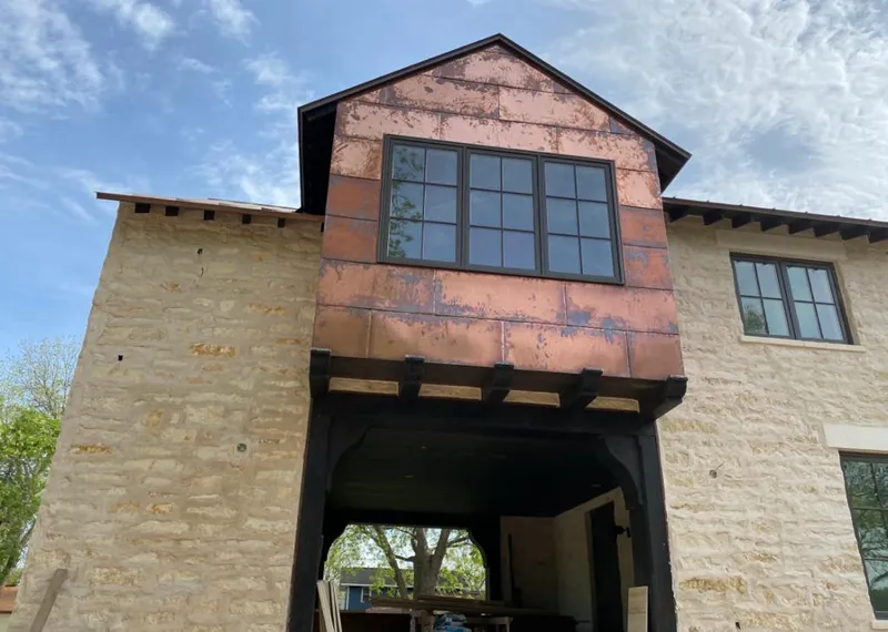 Copper metal panel facade on a stone building for Skylight Installation in Rockledge